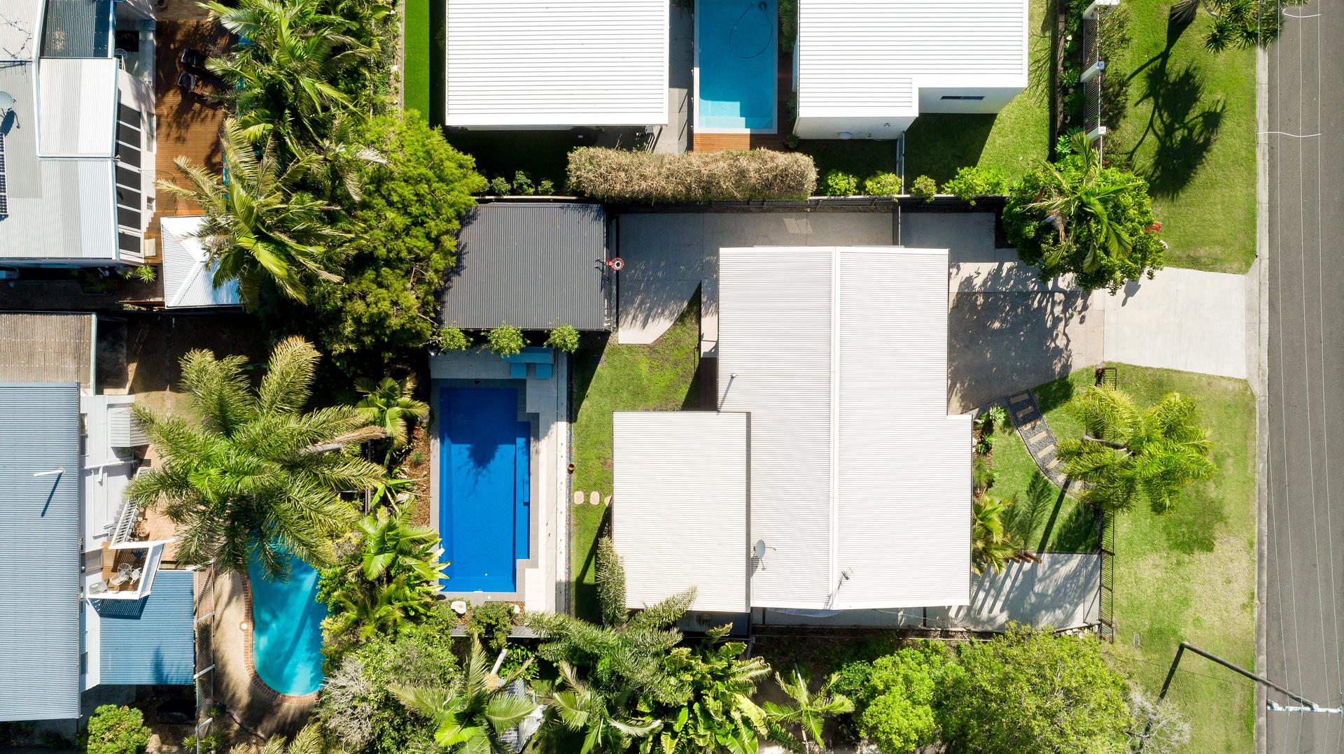 Aerial view showing the house, pool, outdoor living areas and separate garage/shed
