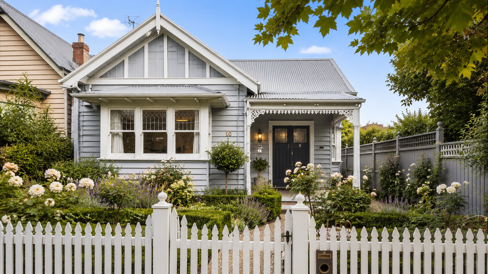 Renovated weatherboard cottage frontage with repainted timber and a simple front garden